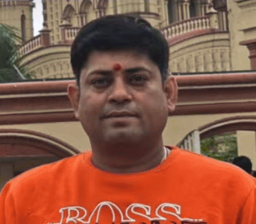 A indian young man in orange t-shirt.